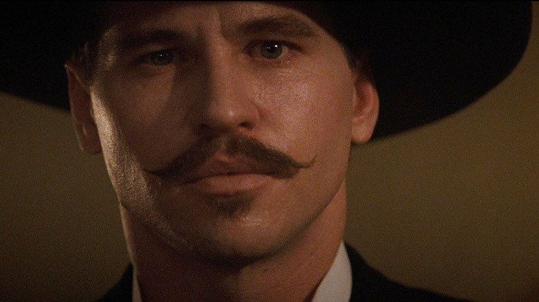 Val Kilmer as Doc Holliday staring intensely in Tombstone