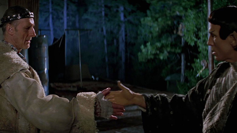 Zefram Cochrane shaking hands with a Vulcan in Star Trek: First Contact