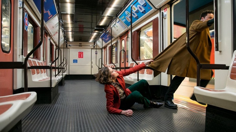 a woman grabs a guy's jacket