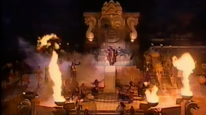 Still from Super Bowl 1995 Halftime show with Patty LaBelle on stage, lots of fire, and an elaborate Indiana Jones temple behind her