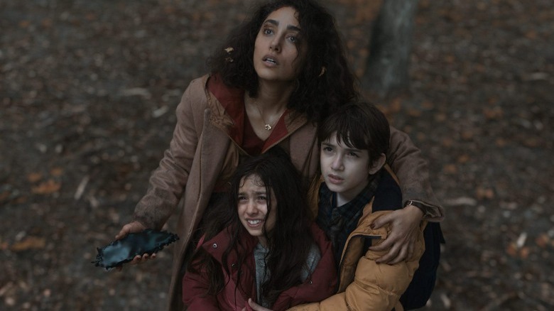 Aneesha hugs children, looks up