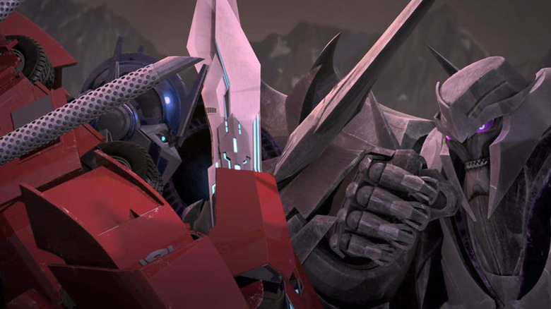 Transformers: Prime - Optimus Prime and Megatron with swords locked in combat