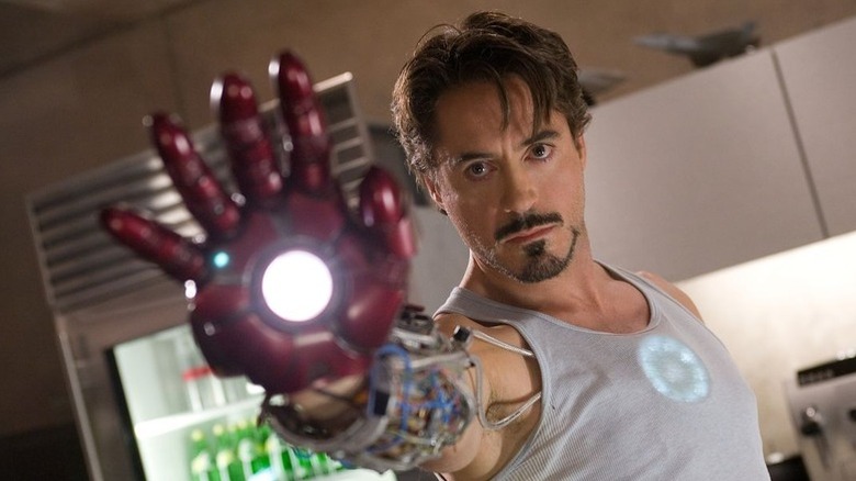 Tony Stark points his gauntlet at the screen in Iron Man
