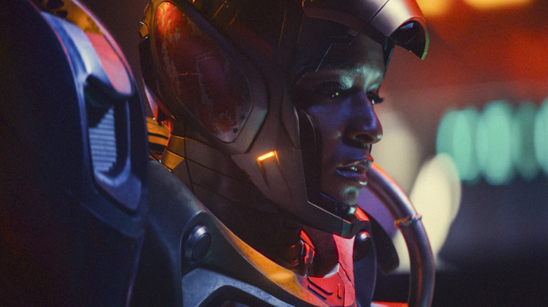 Domonique Thorne as Riri Williams with the mask pulled up on her armor in Ironheart