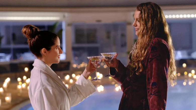 Emily and Stephanie toasting martinis by the pool in Capri in Another Simple Favor
