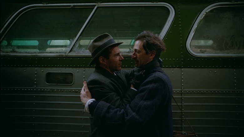 László Tóth embracing Harrison Lee Van Buren in The Brutalist