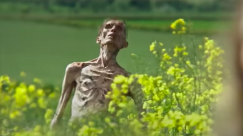 Angus Neill as Emaciated Zombie rising out of a field in 28 Years Later