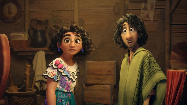 Mirabel standing with Bruno as they both look concerned in Encanto