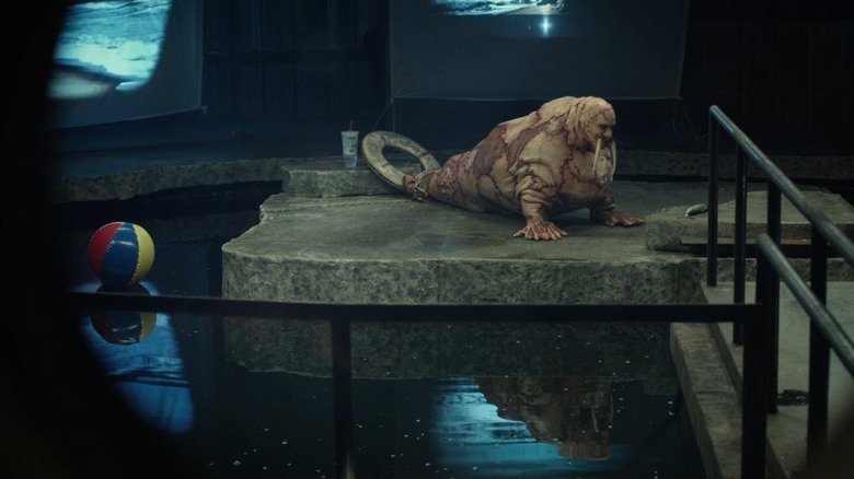 A lonely walrus-man hybrid (played by Justin Long) sits by his pool in Tusk