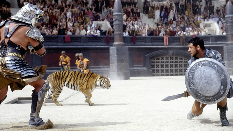 Maximus (Russell Crowe) fighting a gladiator and tiger in the arena in Gladiator
