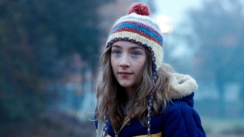 Susie wearing a striped hat outside in The Lovely Bones