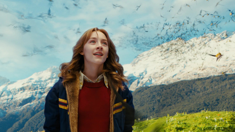 Susie in an idyllic mountain setting watching birds fly in The Lovely Bones