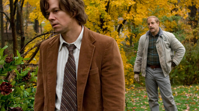 Jack outside with George standing behind him talking in The Lovely Bones