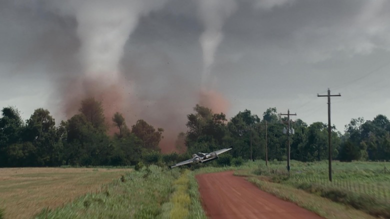 A plane flying toward two twisters in Twisters