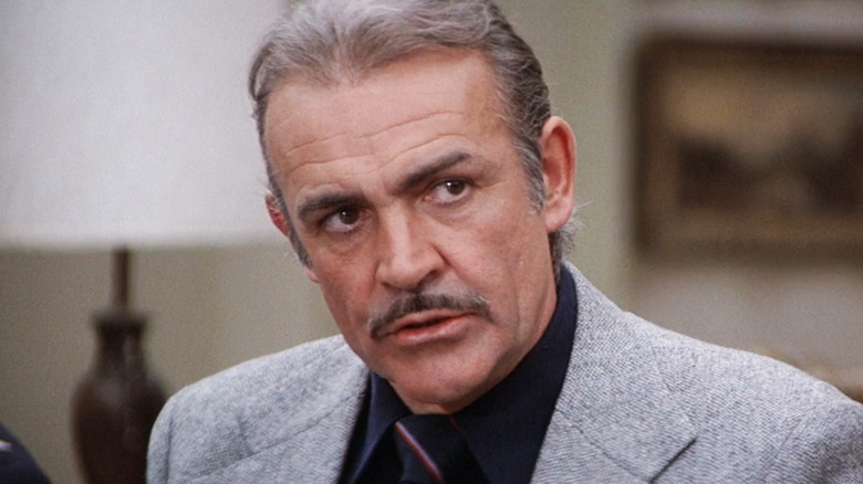 Sean Connery's Dr. Paul Bradley is seen in closeup as he sits in an office in Meteor