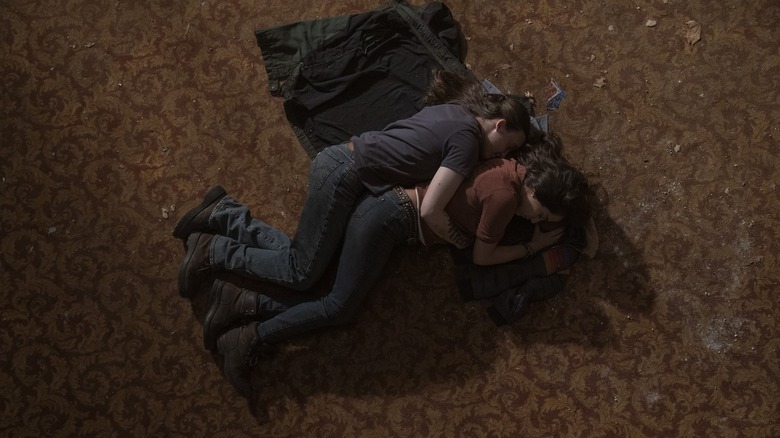 Dina and Ellie spooning in the theater in The Last of Us