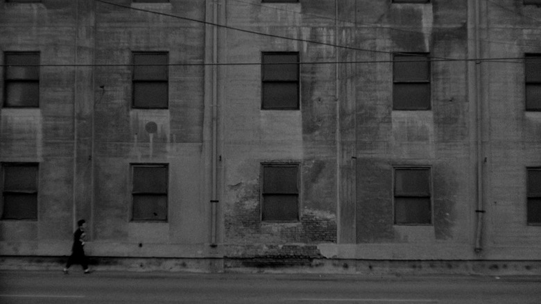 Henry walking in an industrial wasteland in Eraserhead