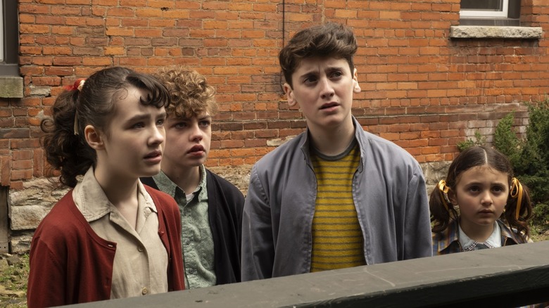 Clara Stack as Lilly, Mikkal Karim-Fidler as Teddy, Jack Molloy Legault as Phil, and Hunter Storm Baker as Suze looking concerned on It: Welcome to Derry