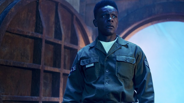 Chris Chalk as Dick Hallorann standing in a sewer in a dream sequence in It: Welcome to Derry