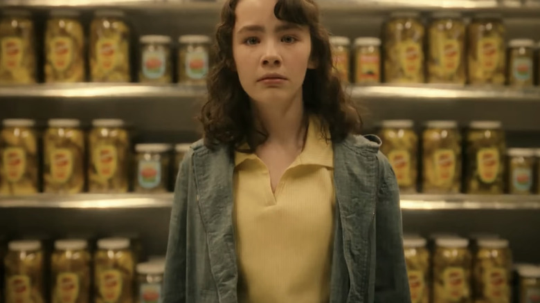Clara Stack's Lilly Bainbridge looks scared in a grocery store in It: Welcome to Derry