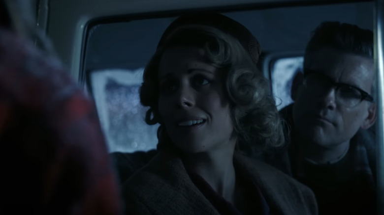 Mark MacRae's Young Father and Zoë Barrett-Wood's Young Mother look out of a car window in It: Welcome to Derry