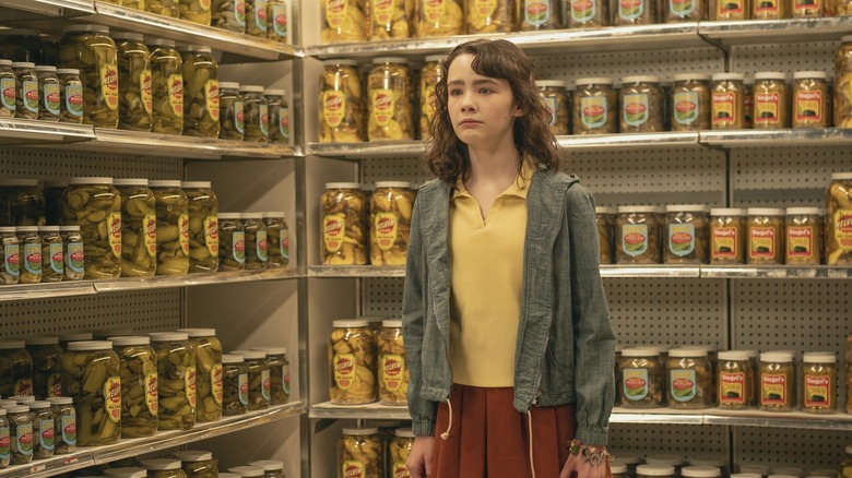Lilly Bainbridge surrounded by pickles in It: Welcome to Derry