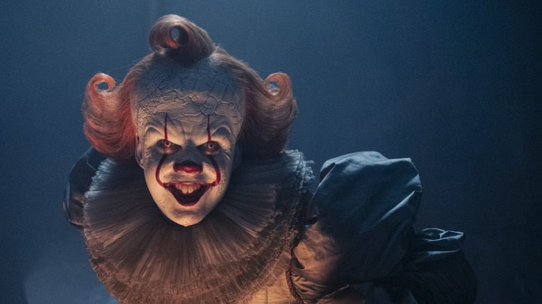 Pennywise grinning like a creep in It: Welcome to Derry