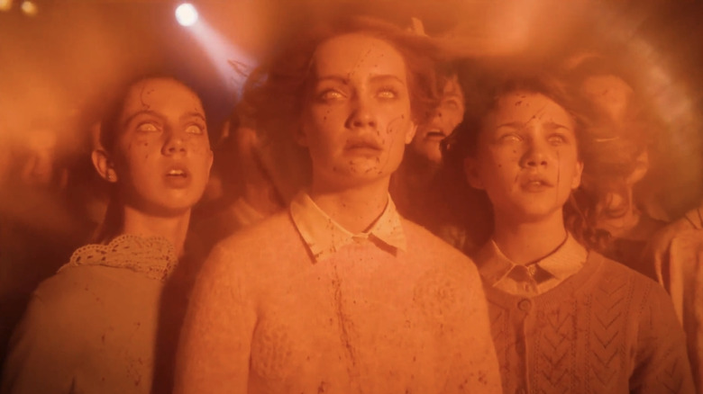 Maya McNair's Patricia Stanton, Hannah Storey's Rhonda Chamber, and Maya Misaljevic's Elaine Morrison stand in a trance in It Welcome to Derry