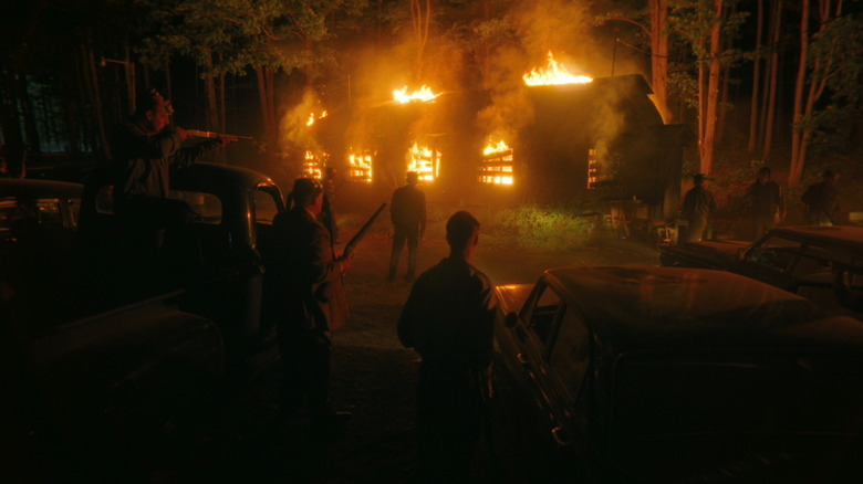 The Maine Legion of White Decency wait outside the Black Spot bar as it burns in It Welcome to Derry