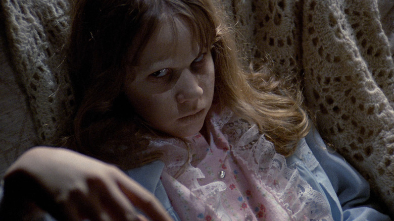 Linda Blair as Regan MacNeil staring menacingly in The Exorcist