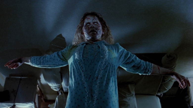 A possessed Regan floating above her bed in The Exorcist