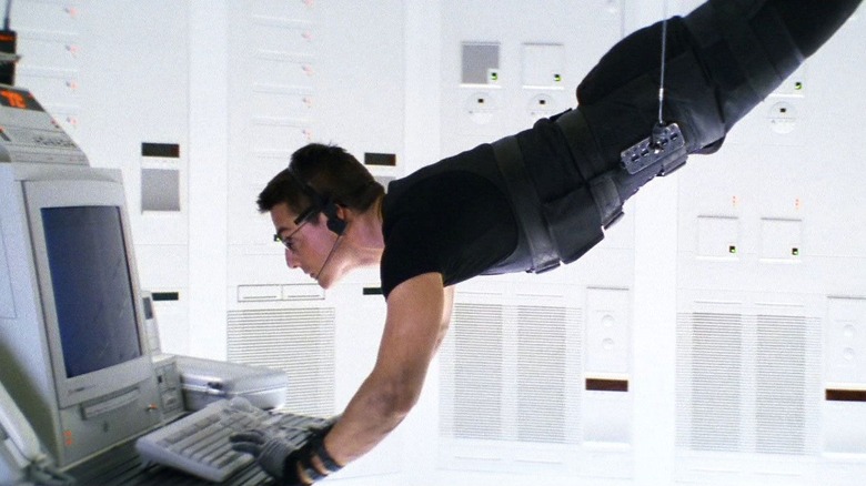 Tom Cruise in the role of Ethan Hunt hanging from the ceiling in the clean CIA room in the mission: impossible