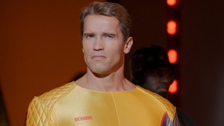 Arnold Schwarzenegger as Ben Richards on stage in his uniform in The Running Man
