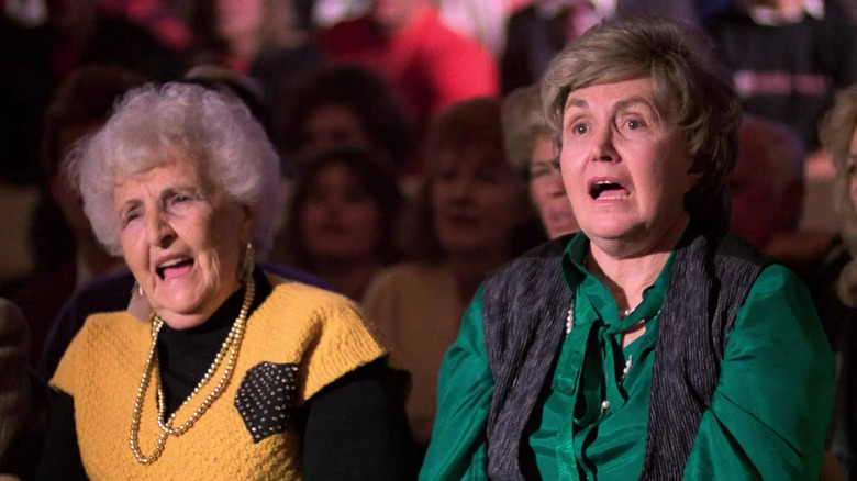 Two older women in the audience responding in The Running Man
