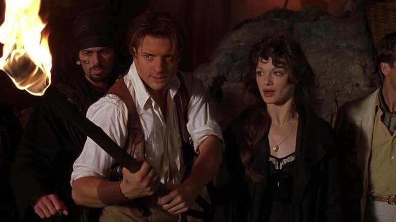 Rick holding a torch next to Evelyn in The Mummy (1999)