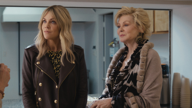 D.J. (Kaitlin Olson) and Deborah (Jean Smart) standing and looking at someone on Hacks