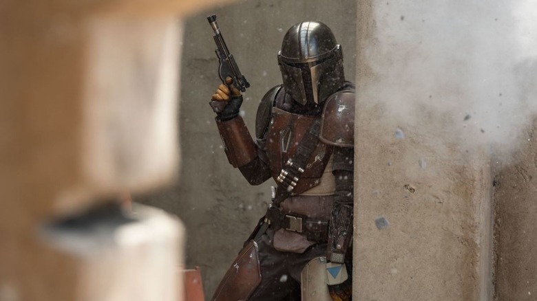 Mando holding a gun in The Mandalorian