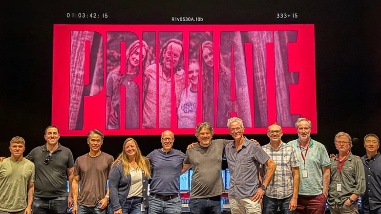 Johannes Roberts posing with the crew in the editing room while making Primate