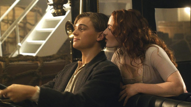 Rose whispering in Jack's ear as he sits in the front seat of the car in Titanic