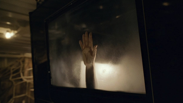 Rose's hand on the steamy window glass in the car belowdecks in Titanic