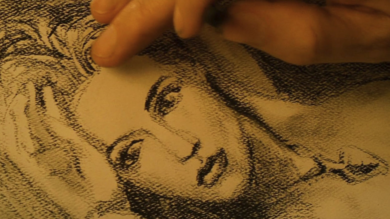 James Cameron's hands standing in for Jack's as he draws Rose in Titanic