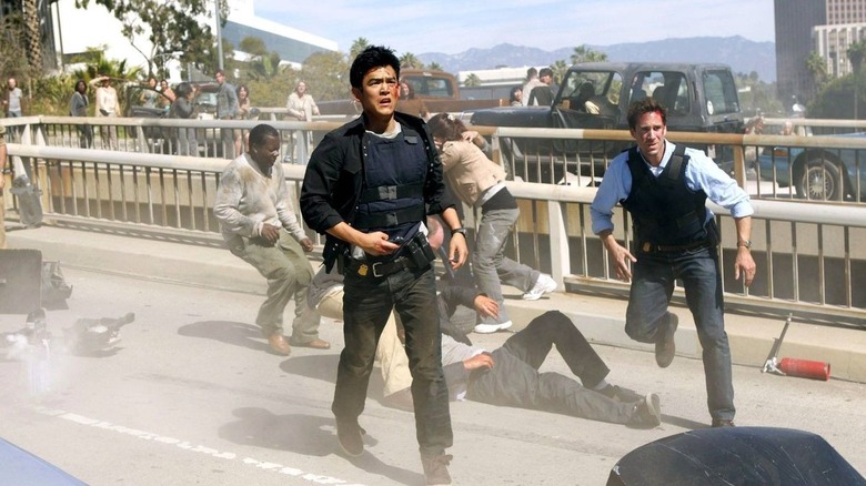 John Cho as Demetri Noh running on a highway in the middle of a major accident next to Joseph Fiennes as Mark Benford in FlashForward