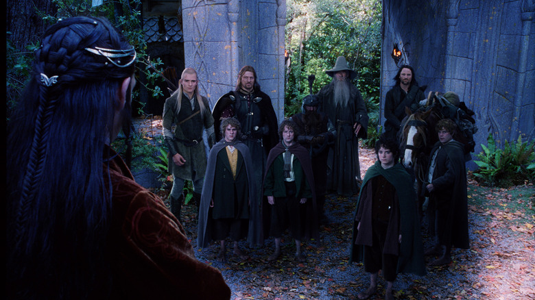 Hugo Weaving as Elrond standing in front of Orlando Bloom as Legolas, Sean Bean as Boromir, Ian McKellen as Gandalf, Viggo Mortensen as Aragorn, Dominic Monaghan as Merry, Billy Boyd as Pippin, Elijah Wood as Frodo and Sean Astin as Sam in The Lord of the Rings: The Fellowship of the Ring