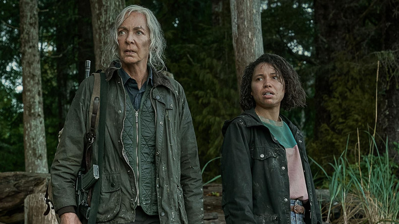 Allison Janney as Loud Adell standing next to Jurnee Smollett as Hannah Dawson in the wilderness in Lou