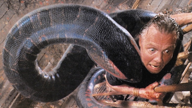 Jon Voight as Paul Serone is wrapped up by a giant anaconda in Anaconda
