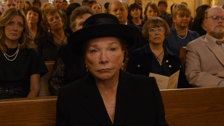 Shirley MacLaine as Marjorie Nugent sitting in church in Bernie