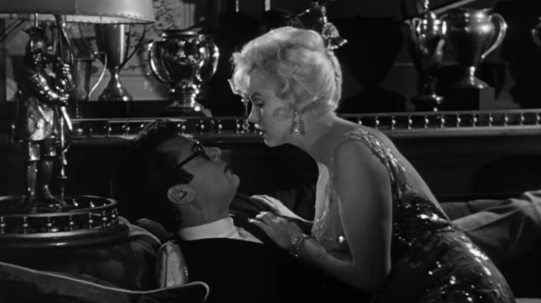 Tony Curtis cozies up to Marilyn Monroe