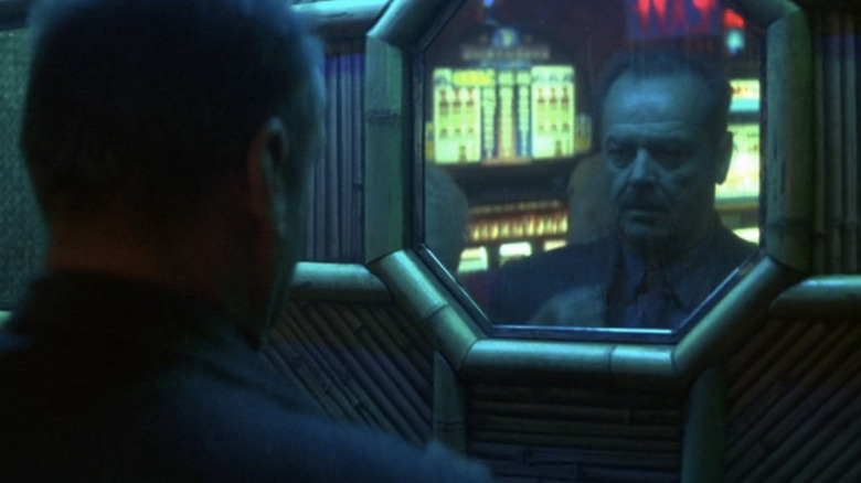 Jack Nicholson's Jerry Black checks his reflection in a doorway mirror in The Pledge