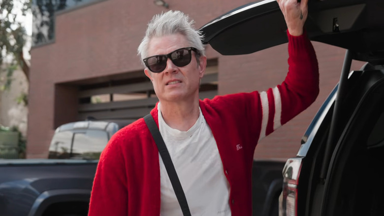 Johnny Knoxville holding up the hatch of an SUV in Jackass: Best and Last