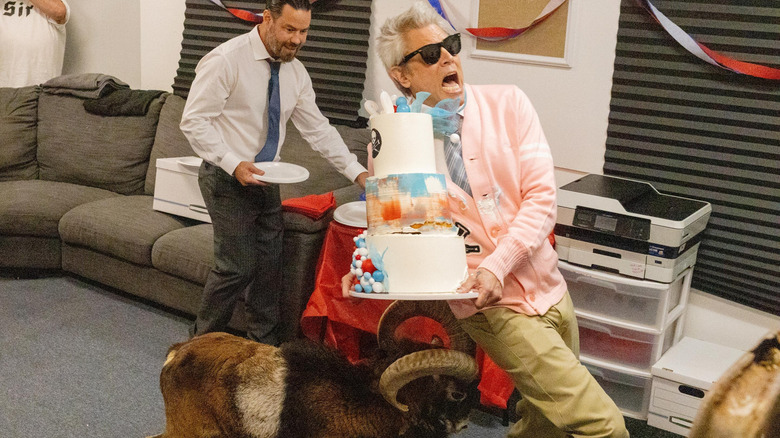 Johnny Knoxville getting rammed by a ram while holding a cake as Chris Pontius watches in Jackass: Best and Last